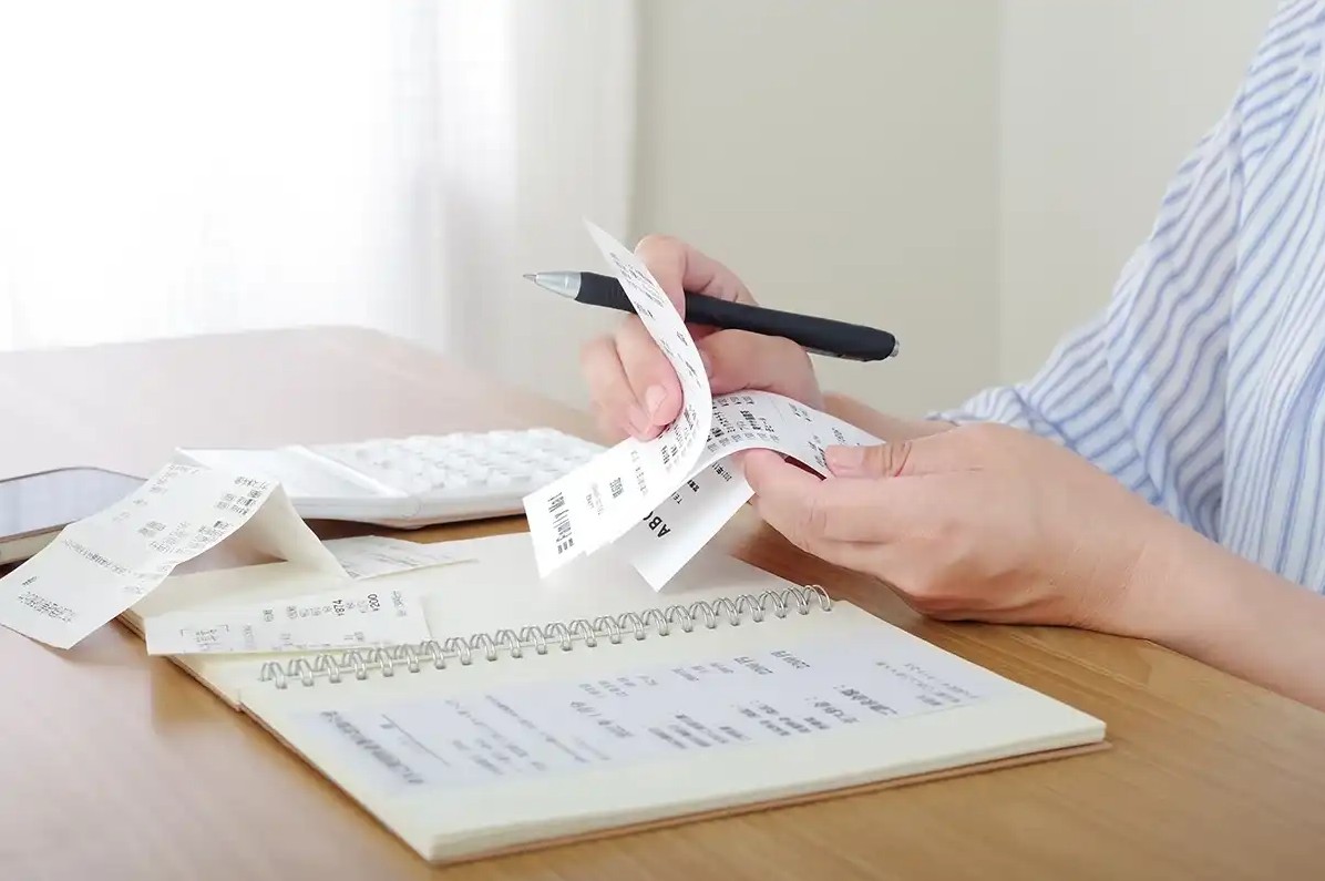 A gig worker looking through their bills and earnings