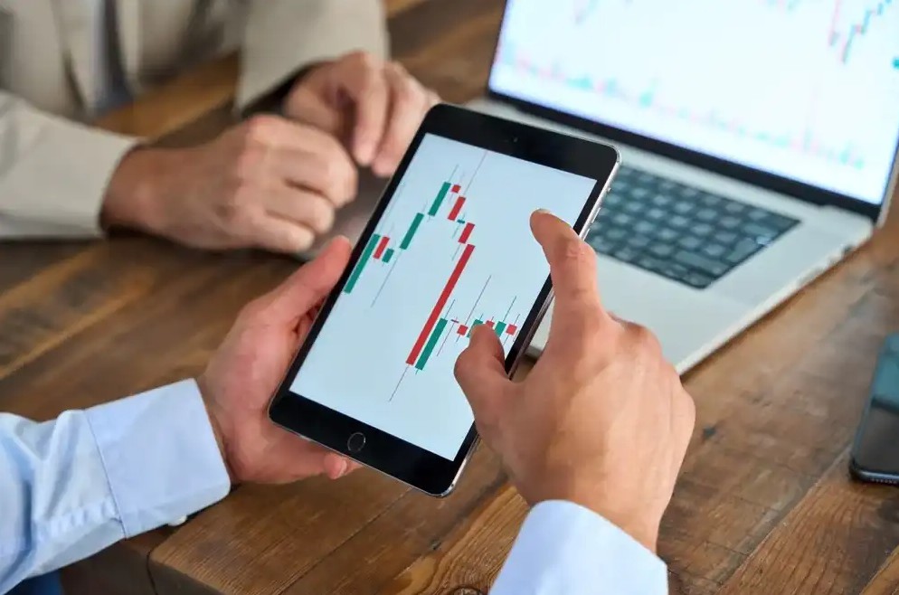 Someone researching stocks on phone for investing