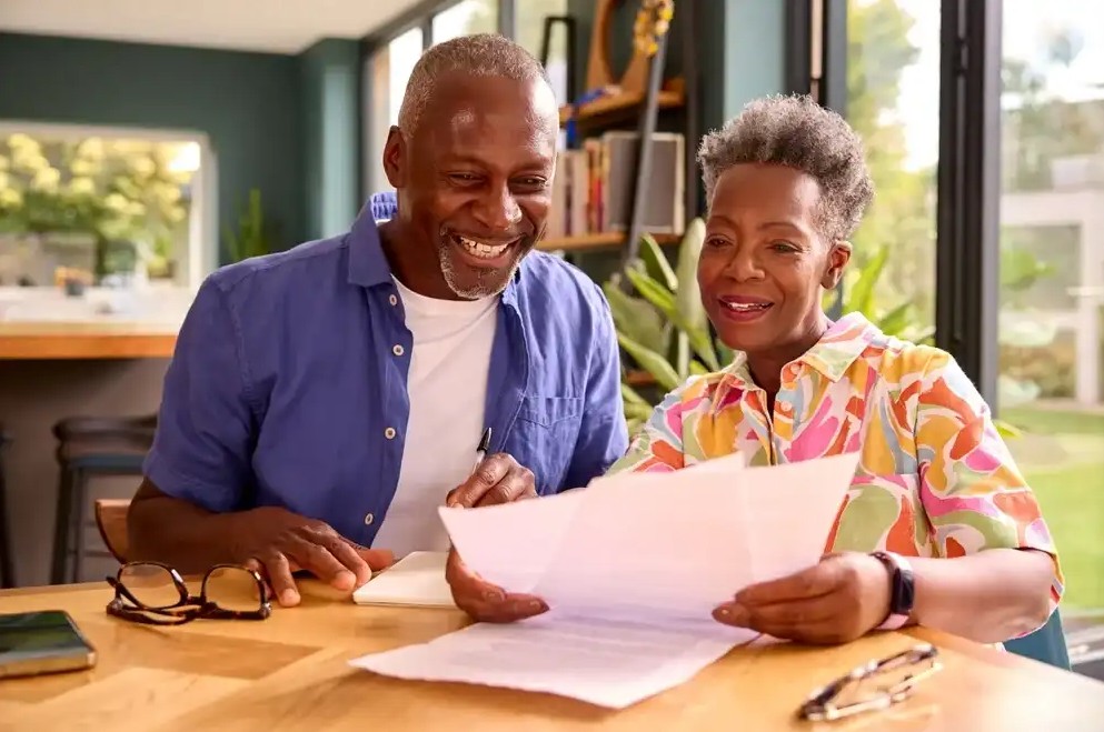 Elderly couple reviewing refinance documents