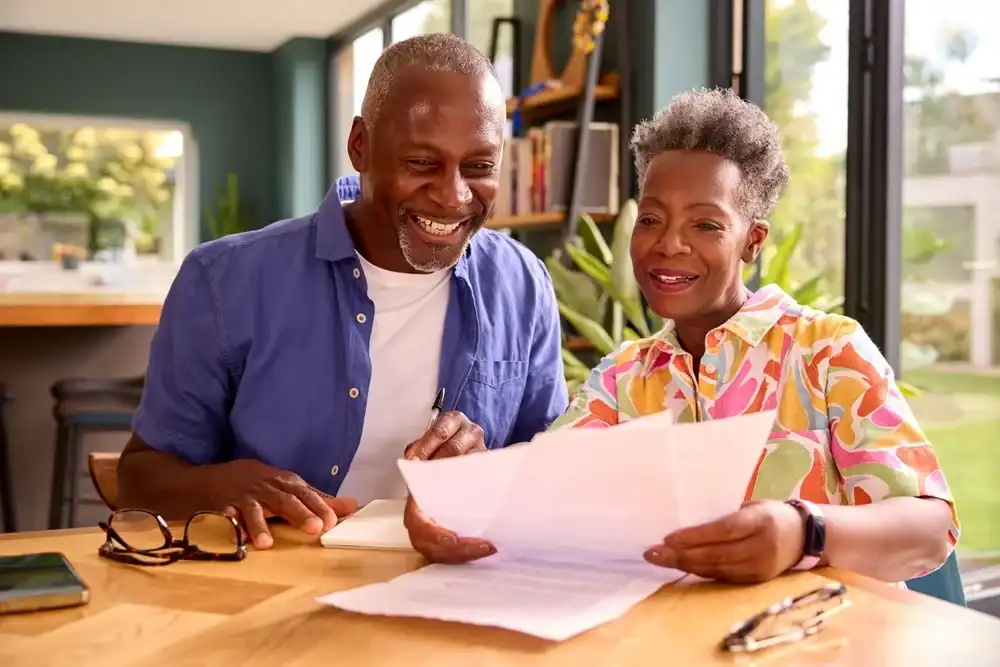 Elderly couple reviewing the benefits of refinancing their loan