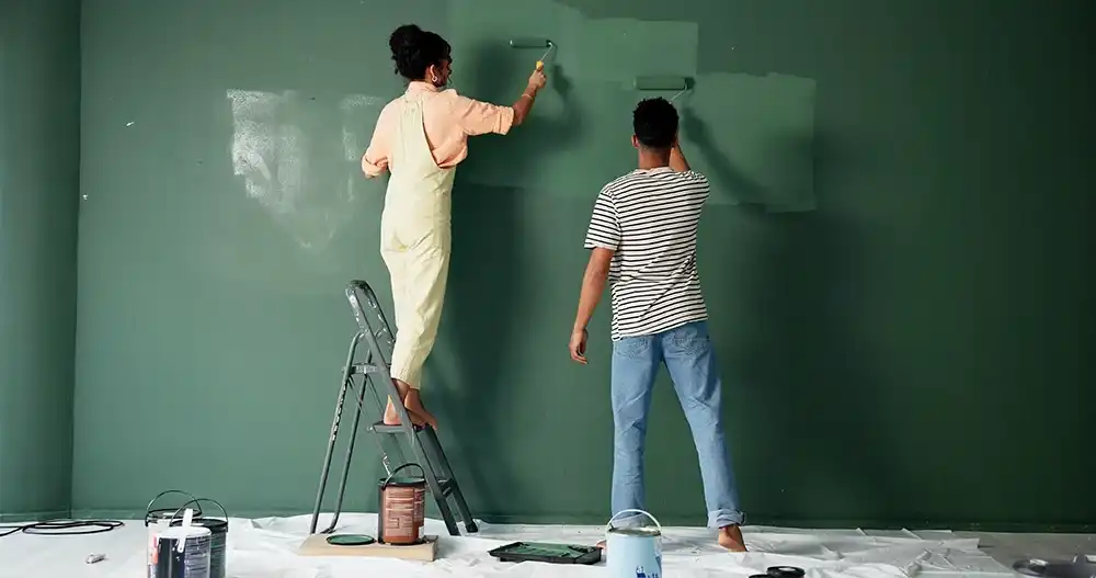 A couple painting their house