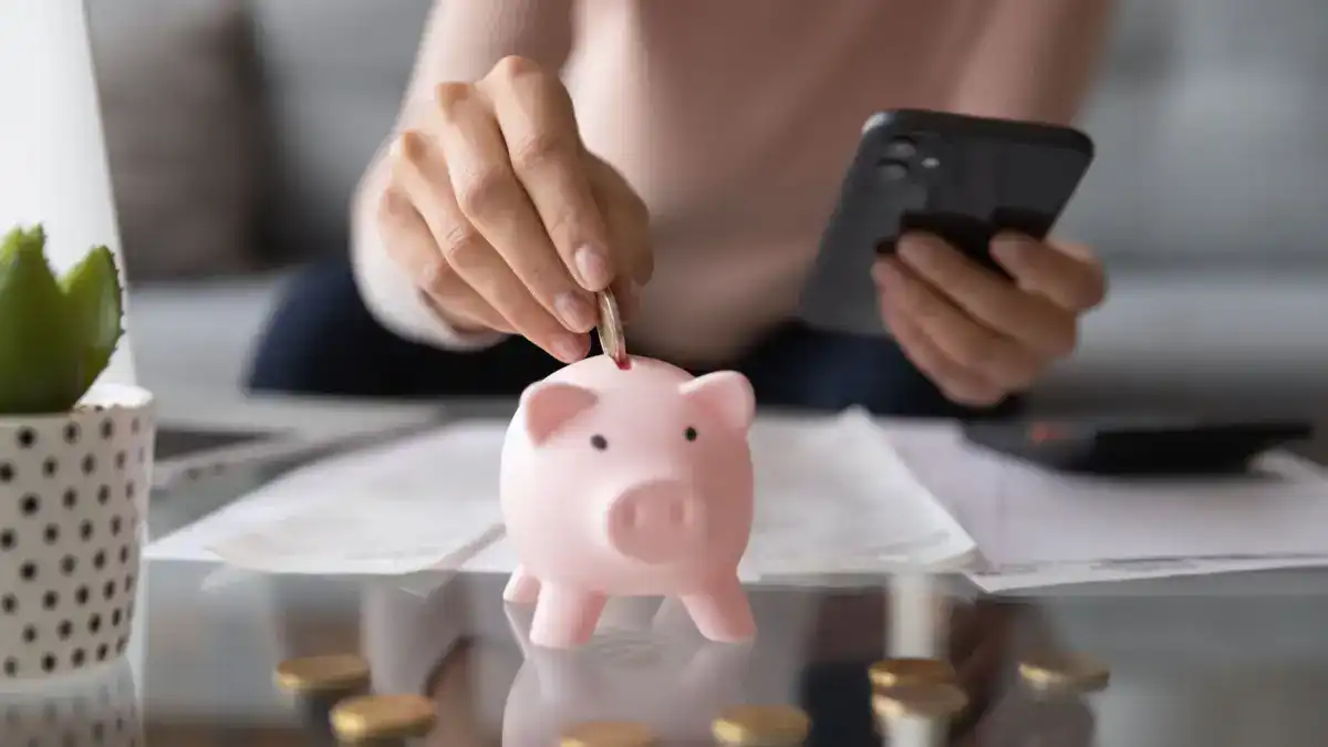 Person on a mobile app saving money in their piggy bank