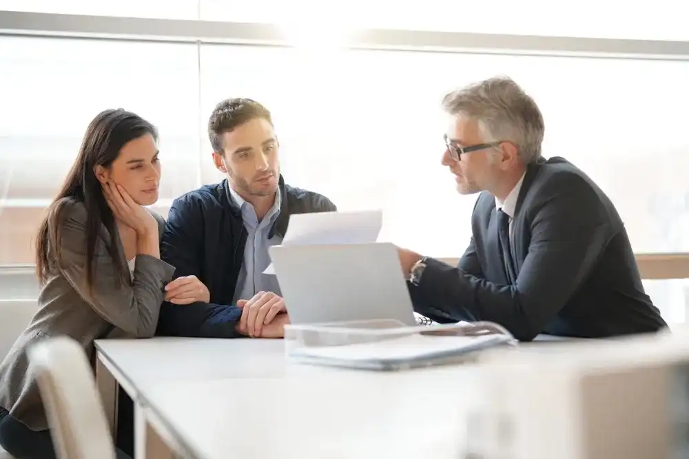 A financial planner going over a plan with a couple for their financial future