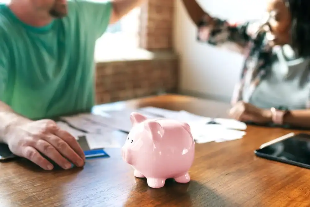 A couple going over their finances together in front of a piggy bank