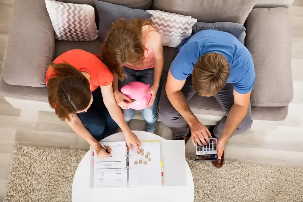 Parents with their teenager setting up a bank account for them