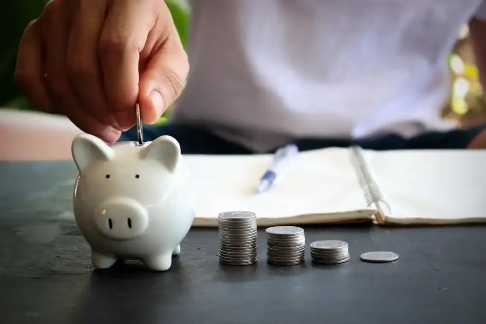 A man saving money in a piggy bank