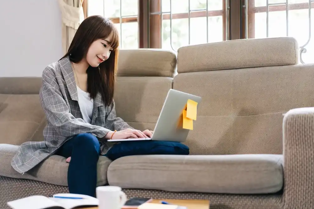 A gig worker typing on their laptop