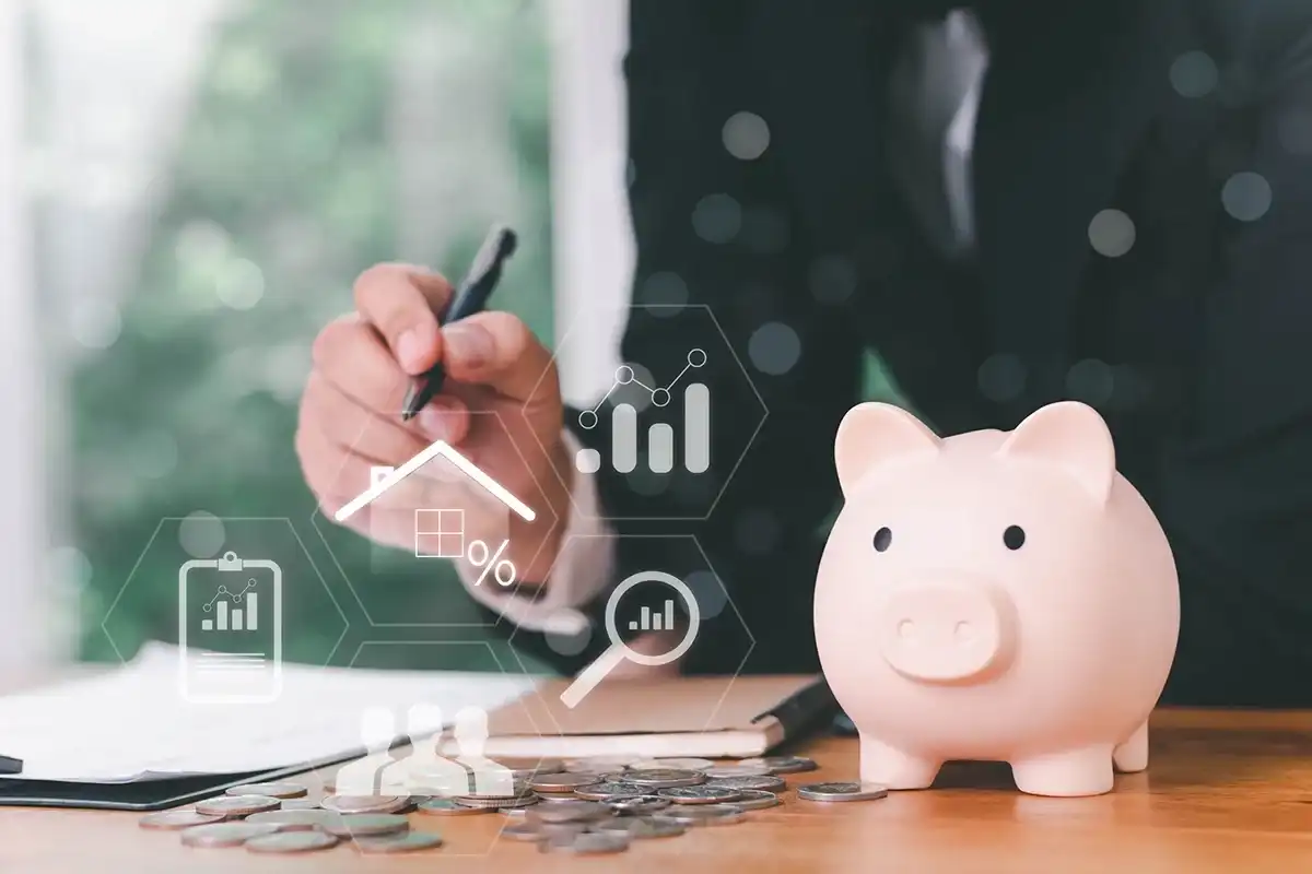 Person calculating payday loan interest rates next to a piggy bank