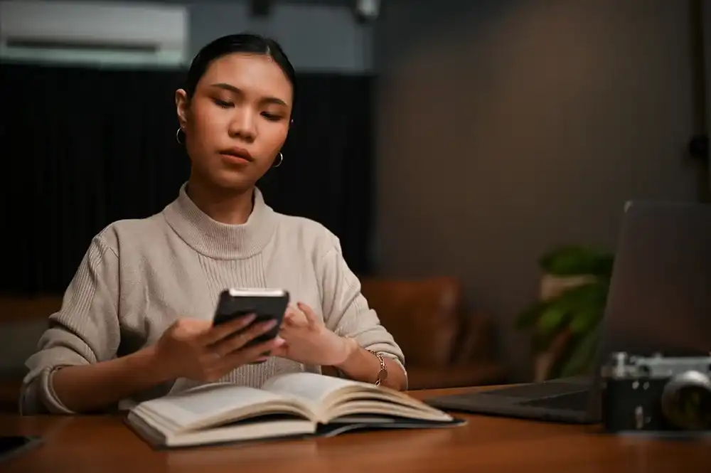 A woman looking up financial terms on her phone